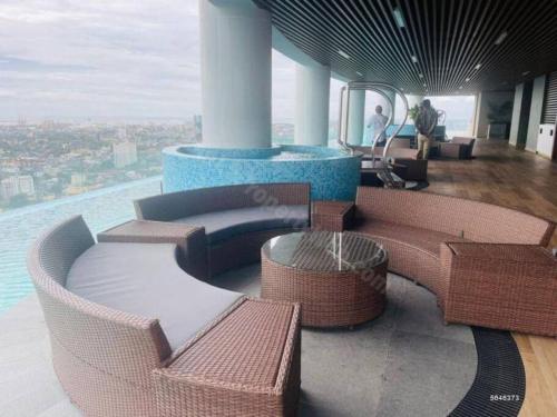 a room with wicker chairs and tables on a building at The Grand Luxury Apartment in Heart of Colombo (Ward Place Col 07) in Colombo