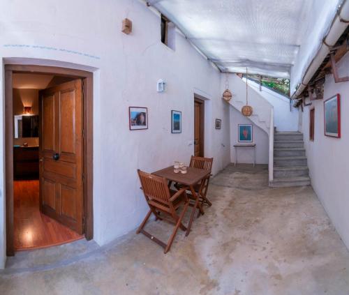 a room with a table and chairs and stairs at El Cervunal in Arenas de San Pedro