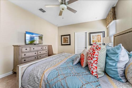 a bedroom with a bed and a dresser with a tv at Modern 8-Bed Champions Gate Disney Magic Awaits in Davenport