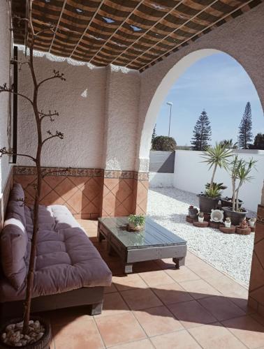 a living room with a couch and a table at Chalet "El Paraíso del Cabo" Retamar El Toyo Golf in Retamar