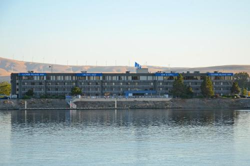 a large building on the shore of a body of water at Clover Island Inn in Kennewick
