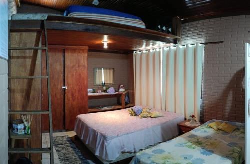 a bedroom with a bunk bed and a ladder at Espaço Mezanino in Mairiporã