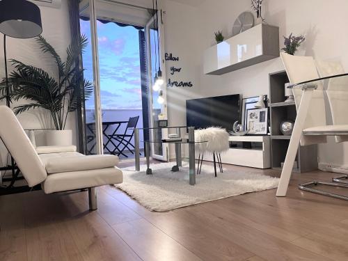 a living room with a table and chairs and a tv at Apartment New Chic in Supetar