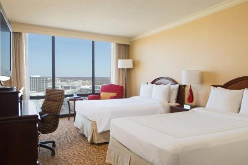 a hotel room with two beds and a large window at Chicago Marriott Oak Brook in Oak Brook