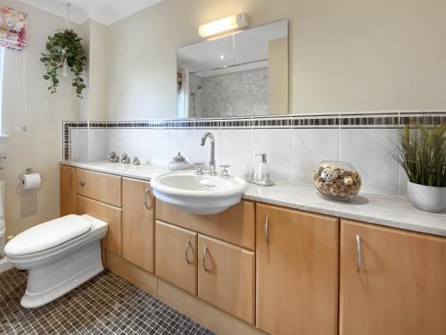 a bathroom with a sink and a toilet and a mirror at Pilots Rest in Acklington