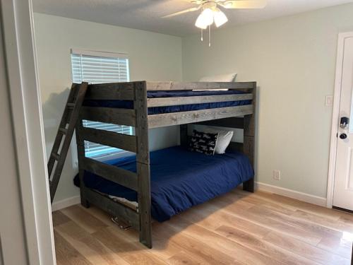 a bedroom with a bunk bed with a blue blanket at Bella's Beach House 2811 Avenue O 1/2 in Galveston