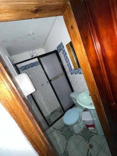 an overhead view of a bathroom with a toilet and a sink at Hostal Don Viche in Mindo