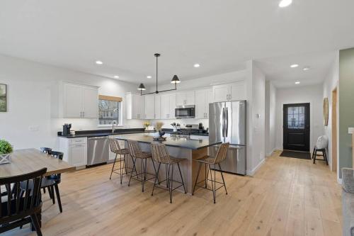 a kitchen with white cabinets and a table and chairs at Dells Domain 2.0 in Wisconsin Dells