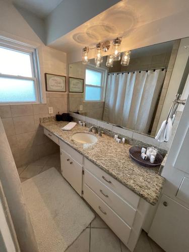 a bathroom with a sink and a large mirror at The Terrace Room @ Galleria in Houston