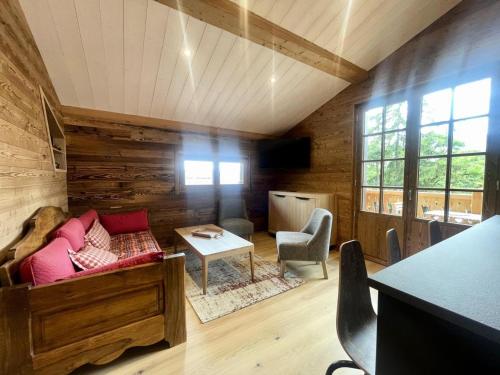 a living room with a couch and a table at Chalets Abbe/tot - Chalet de Tôt MAE-4004 in Crest-Voland