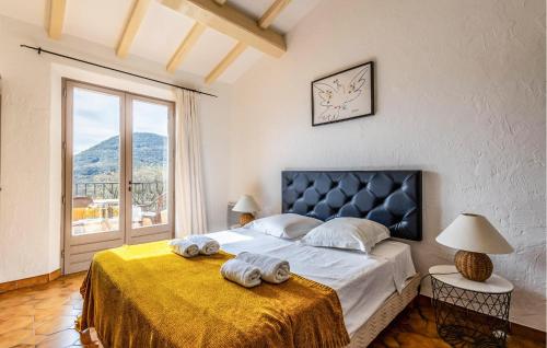 a bedroom with a large bed with towels on it at Gorgeous Home In Les Adrets-de-lestre With Wifi in Les Adrets de l'Esterel