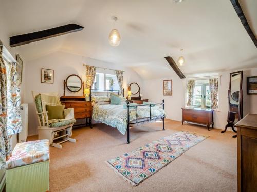a bedroom with a bed and a desk and mirror at Cherry Tree Cottage - Uk30237 in Great Snoring