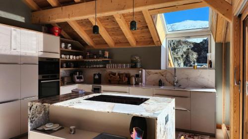 a kitchen with a large island in the middle at Chalet Totoro - Chalets pour 14 Personnes 514 in Valloire