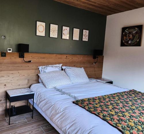 a bedroom with a large bed with two pillows at Chalet Totoro - Chalets pour 14 Personnes 514 in Valloire
