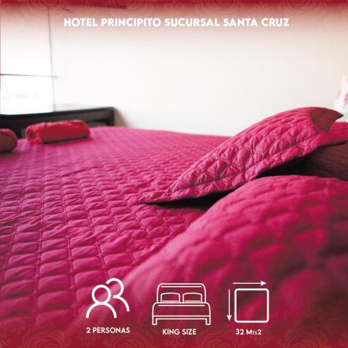 a bed with a pink comforter and pillows on it at PRINCIPITO SANTA CRUZ in Santa Cruz de la Sierra
