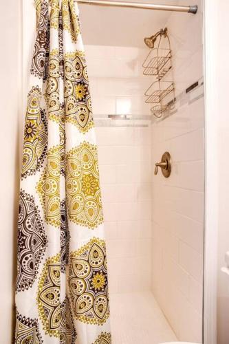 a shower curtain in a bathroom with a shower at Bethany Ocean View Condo by the sea 1st of 2 in Ocean View