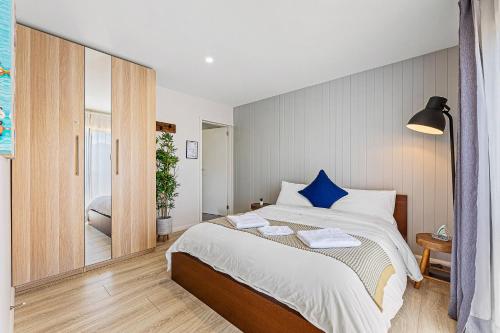 a bedroom with a large bed and a mirror at Paradise Retreat - relax & escape in Potato Point