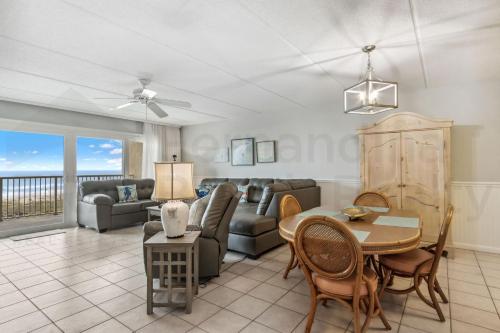 a living room with a couch and a table at Oceanfront Condo w Balcony in Amelia Island