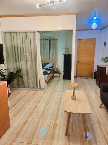 a living room with a bed and a table at Catalena Transient House Bayugan City in Bayugan City