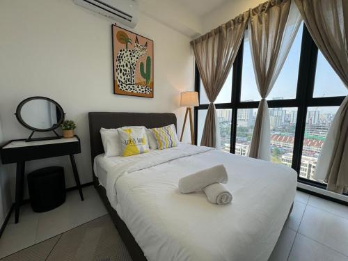 a bedroom with a white bed with a large window at DeLuma-Urban Suites in Jelutong