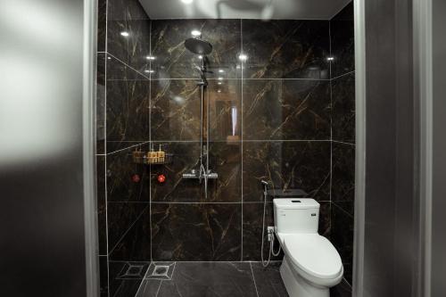a bathroom with a toilet and a shower at Dolce Mia Home Ninh Bình in Ninh Binh