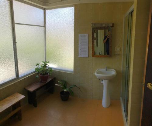 a bathroom with a sink and a mirror at the weekend hostel in La Paz