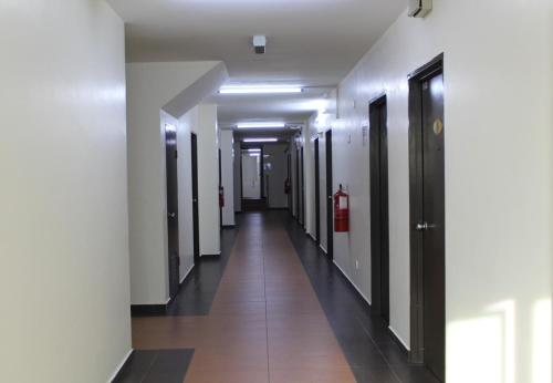 a hallway of a building with a fire extinguisher in it at JQ Suria Hotel in Lahat