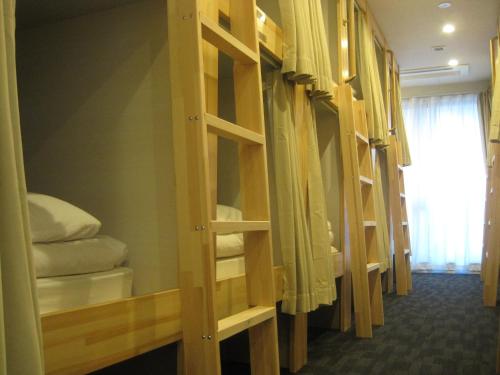 a row of bunk beds in a room at HOTEL PRELE ホテル プレール in Tokyo
