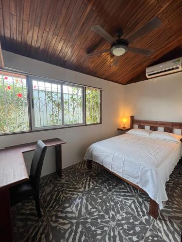 a bedroom with a bed and a ceiling fan at Casa Verde in Uvita