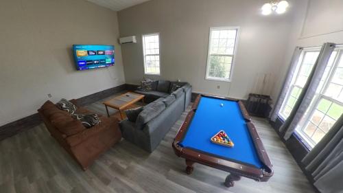 a living room with a pool table in the middle at River Dream Lake Murray Getaway in Saluda