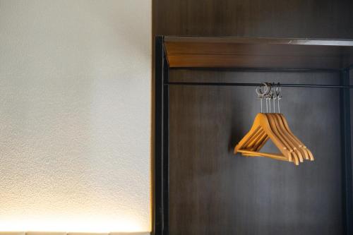 a brown refrigerator with a wooden utensil at Amber Hotel - Cebu in Cebu City
