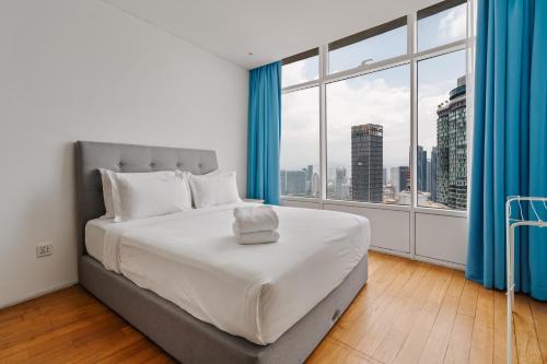 a bedroom with a large bed and a large window at Vortex KLCC Apartments in Kuala Lumpur