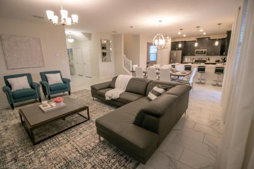 a living room with two couches and a kitchen at 1581 PD - Exquisite 6BR Haven: Private Pool in Davenport