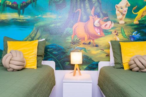a room with two beds and a mural of disney at 1056 LS - Luxury 4BR3BA - Champions Gate Bliss in Kissimmee