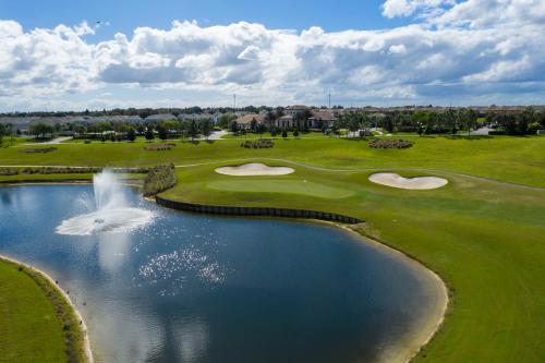 an aerial view of a golf course with a pond at 1056 LS - Luxury 4BR3BA - Champions Gate Bliss in Kissimmee