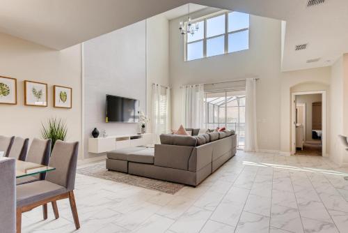 a living room with a couch and a tv at 2751 BD -Luxury 5BR Single Family - Private Pool in Kissimmee
