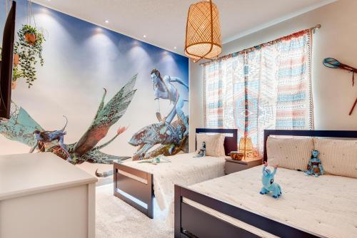 a childs room with two beds and a mural at 2751 BD -Luxury 5BR Single Family - Private Pool in Kissimmee