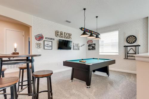 a room with a pool table and some stools at 2751 BD -Luxury 5BR Single Family - Private Pool in Kissimmee