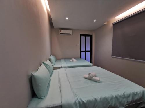 Postel nebo postele na pokoji v ubytování Autumn Guesthouse's near Jalan Alor Bukit Bintang