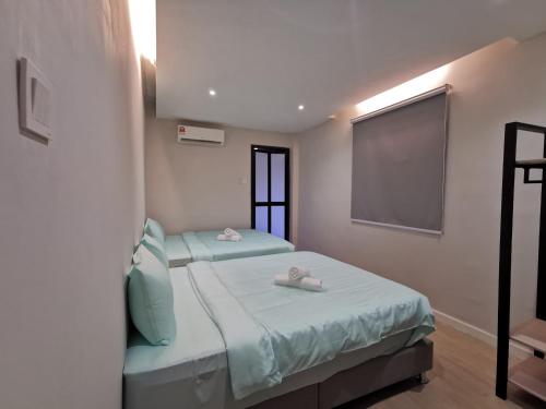 Ένα ή περισσότερα κρεβάτια σε δωμάτιο στο Autumn Guesthouse's near Jalan Alor Bukit Bintang