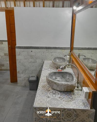 a bathroom with two sinks on a counter at Ocean Prana Village in Amed