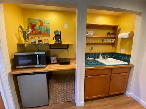 a small kitchen with a sink and a microwave at Garden Cottage Paradise Also Perfect for WFH-ers in Mountain View