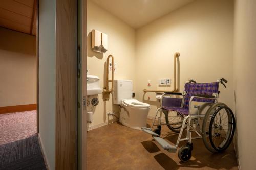 a wheelchair in a hospital room with a toilet at Kami no yama Azumaya in Kaminoyama