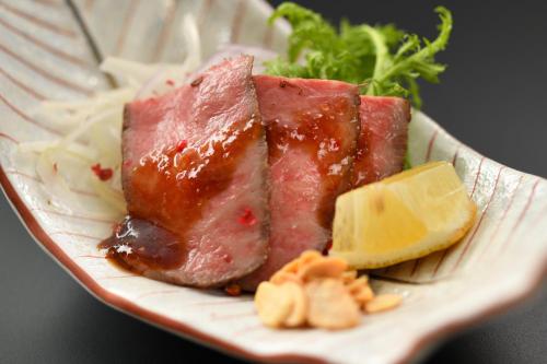 a plate of food with meat and cheese on it at Kami no yama Azumaya in Kaminoyama