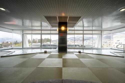 a large room with windows and a pillar in a building at Kami no yama Azumaya in Kaminoyama