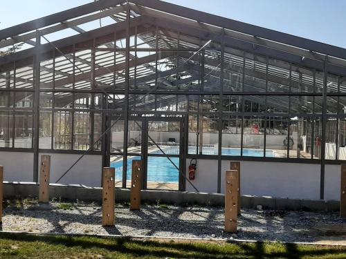 un bâtiment avec piscine intérieure dans l'établissement Charmant Chalet 3 Chambres avec Piscine Couverte à 10 min de la Plage de La Baule - FR-1-783-18, à Guérande