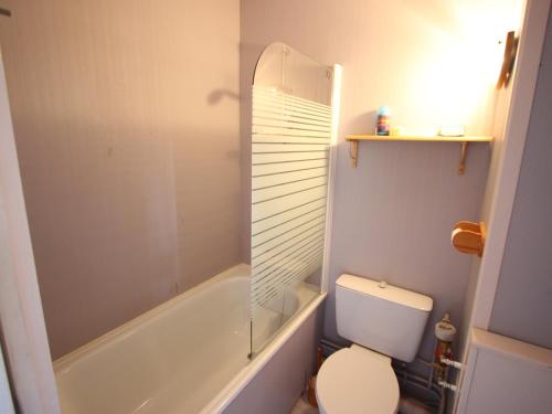 a bathroom with a toilet and a glass shower at Studio Chamrousse, 1 pièce, 4 personnes - FR-1-549-138 in Chamrousse