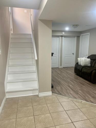 a staircase in a living room with a couch at A bedroom in a basement in Guelph