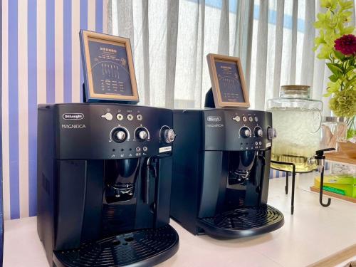 a coffee machine with two certificates on top of it at Loju Seaview Homestay in Xiaoliuqiu