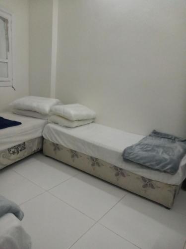 two twin beds sitting in a room at غرف مجاورين المصطفى رباعي in Al Madinah